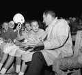 FSU's head football coach Bill Peterson sitting on sideline with Rec. Dept. players in Tallahassee.
