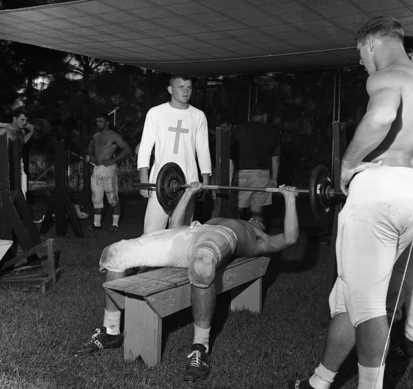 FSU football players lifting weights after practice in Tallahassee.