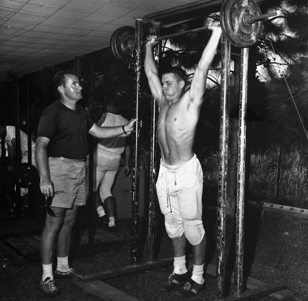 FSU football assistant coach Don James watching player lifting weights after practice in Tallahassee.