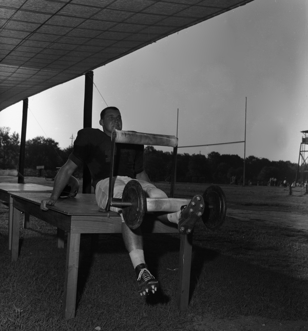 FSU football player Les Murdock lifting weights after practice in Tallahassee.