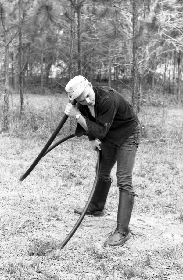 FSU student Jerry Prince listening to a rattlesnake in Grady County, Georgia.