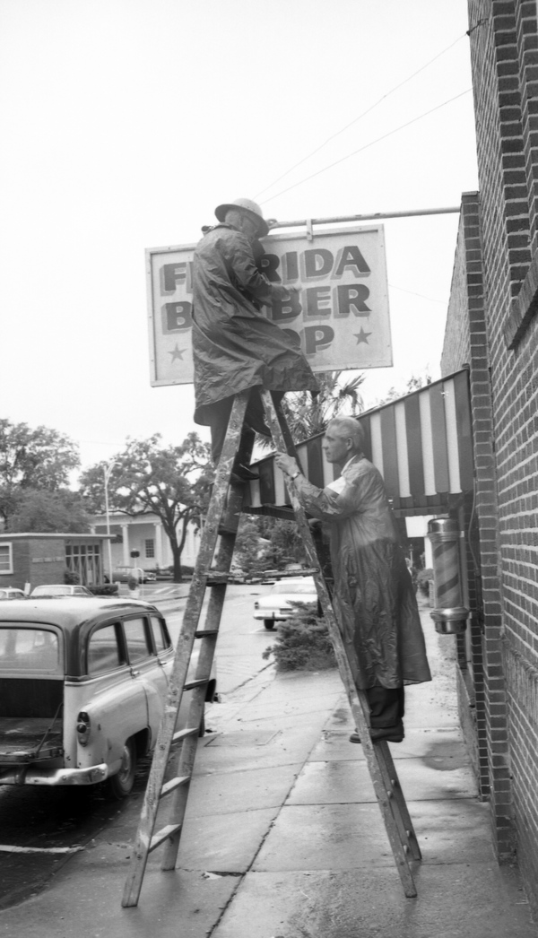 Sign from the Florida Barber Shop in Tallahassee being removed in preparation of Hurricane Alma.