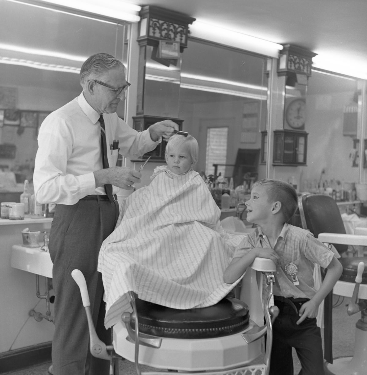Boy getting his first haircut from Tom Fair in Tallahassee.