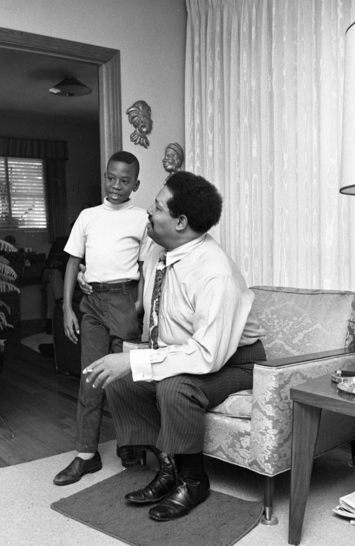 Unidentified boy with Cannonball Adderley at his father's home in Tallahassee.