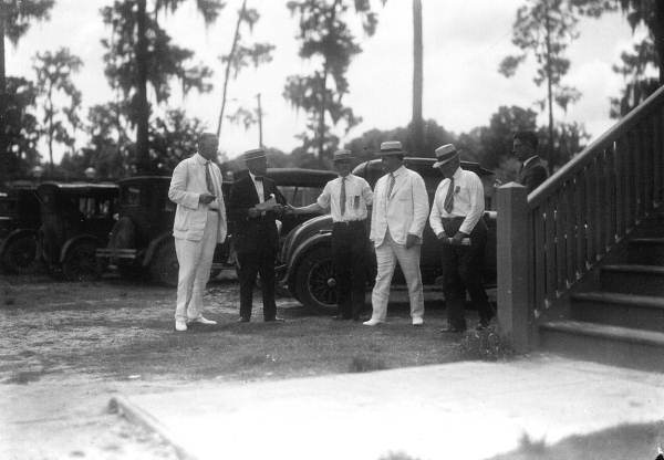 Governor John Martin accompanied by several men