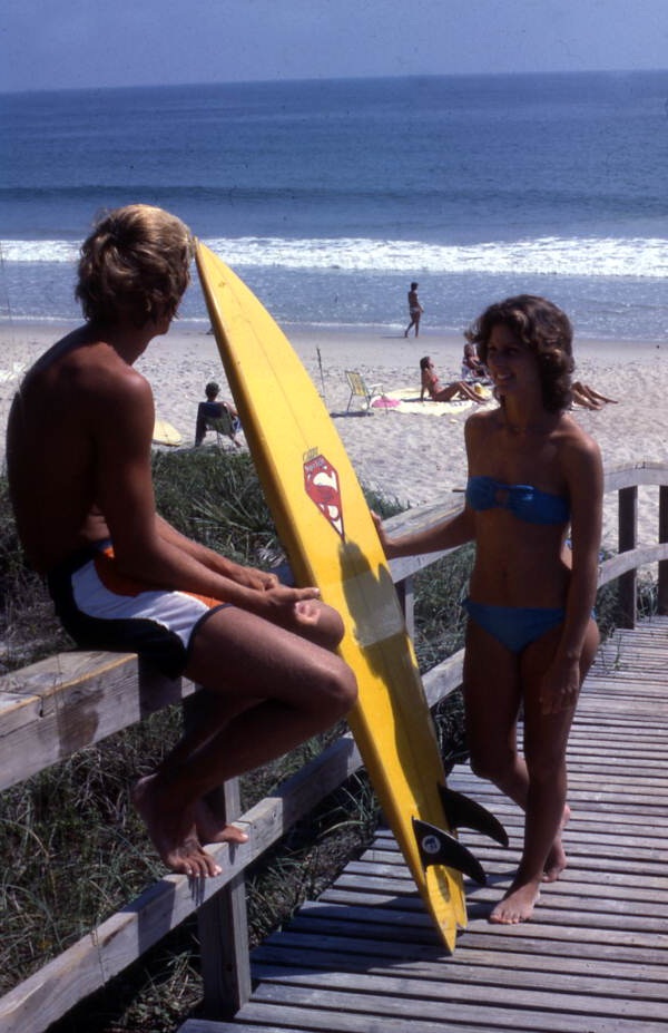 Young people with surfboard at the Canaveral National Seashore beach in Brevard County near Titusville, Florida.