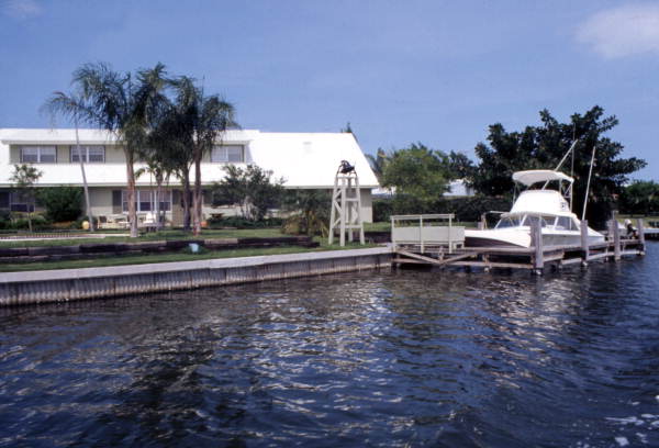 Boat docked next to a waterfront home in Cocoa, Florida.