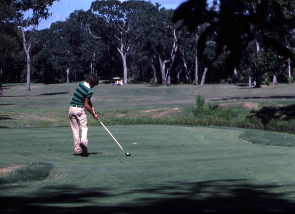View of a golfer teeing off at a course on Amelia Island, Florida.