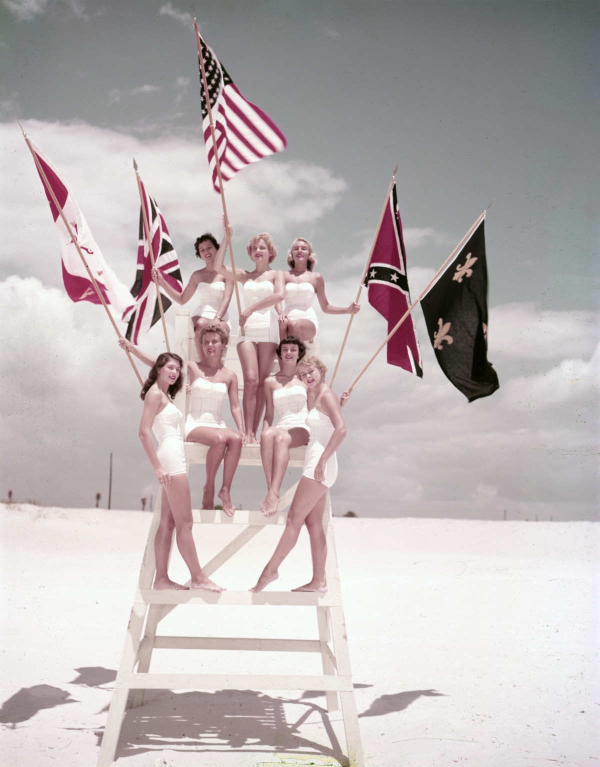 Miss Fiesta contestants posing on lifeguard stand during the Fiesta of Five Flags in Pensacola.
