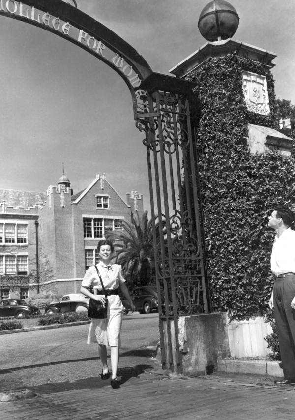 Kitty Chaires and Jerome Allen in front of iron archway, Florida State College for Women - Tallahassee, Florida.