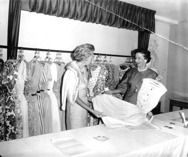 Women looking over dresses at a fashion council