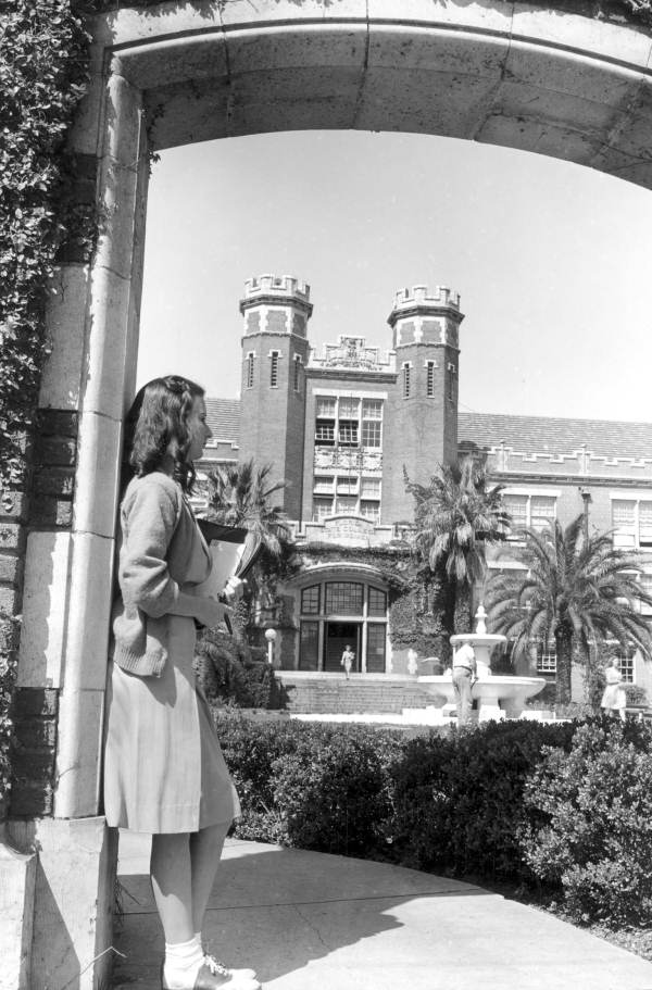 Student leaning against archway in front of the Westcott Building, Tallahassee, Florida.