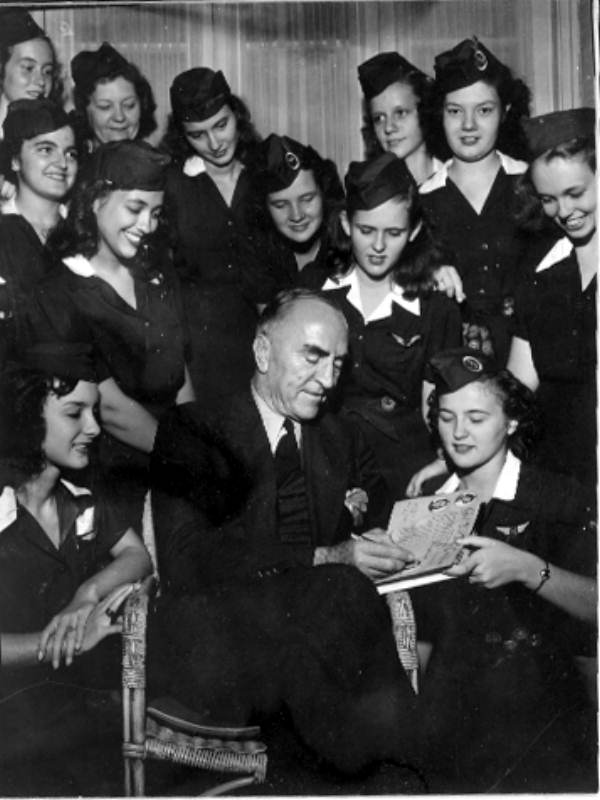 Captain Eddie Rickenbacker autographing for a girl scout