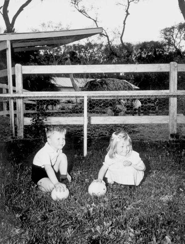 5 year old Michael Powell and 4 year old Linda Mae Powell holding ostrich eggs - Saint Augustine, Florida