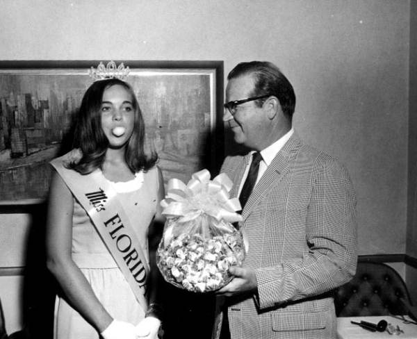 Miss Florida 1968, Linda Fitts, receiving a basket of bubble gum