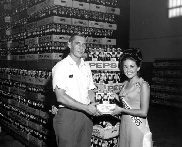Miss Florida 1965, Carol Blum, in a Pepsi Cola bottling plant.