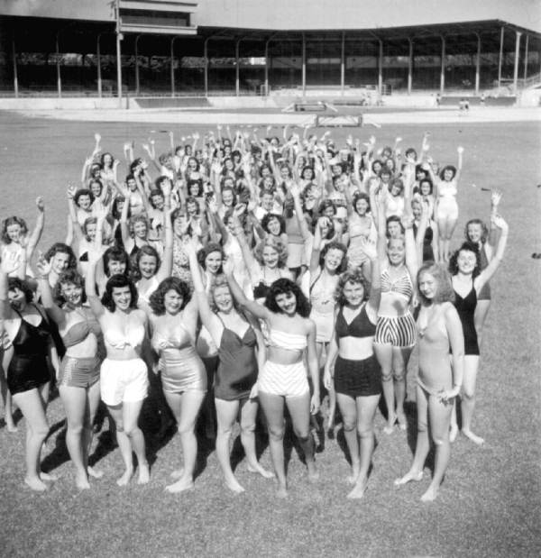 Women from charm school at baseball field waving - Saint Petersburg, Florida.