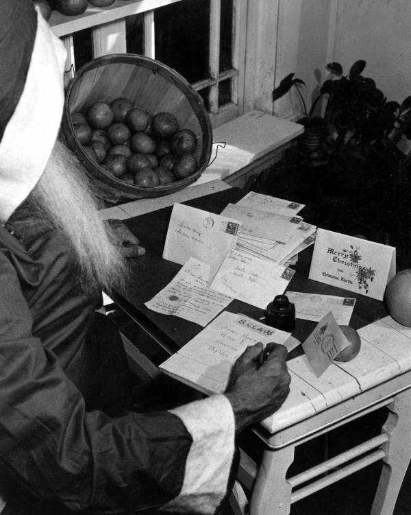 Santa Claus looking over letters - Christmas, Florida