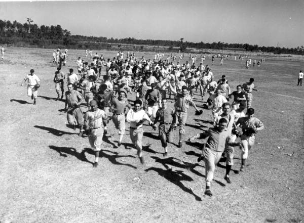 Student baseball players run across the field - Bartow, Florida