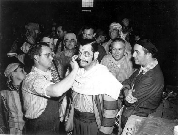 Man applying make-up to costumed pirates at the Gasparilla festival - Tampa, Florida.
