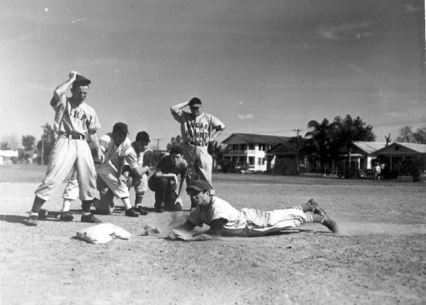 Joe Carapezza dives headfirst toward the base with instructor Bitsy Mott watching - Tampa, Florida