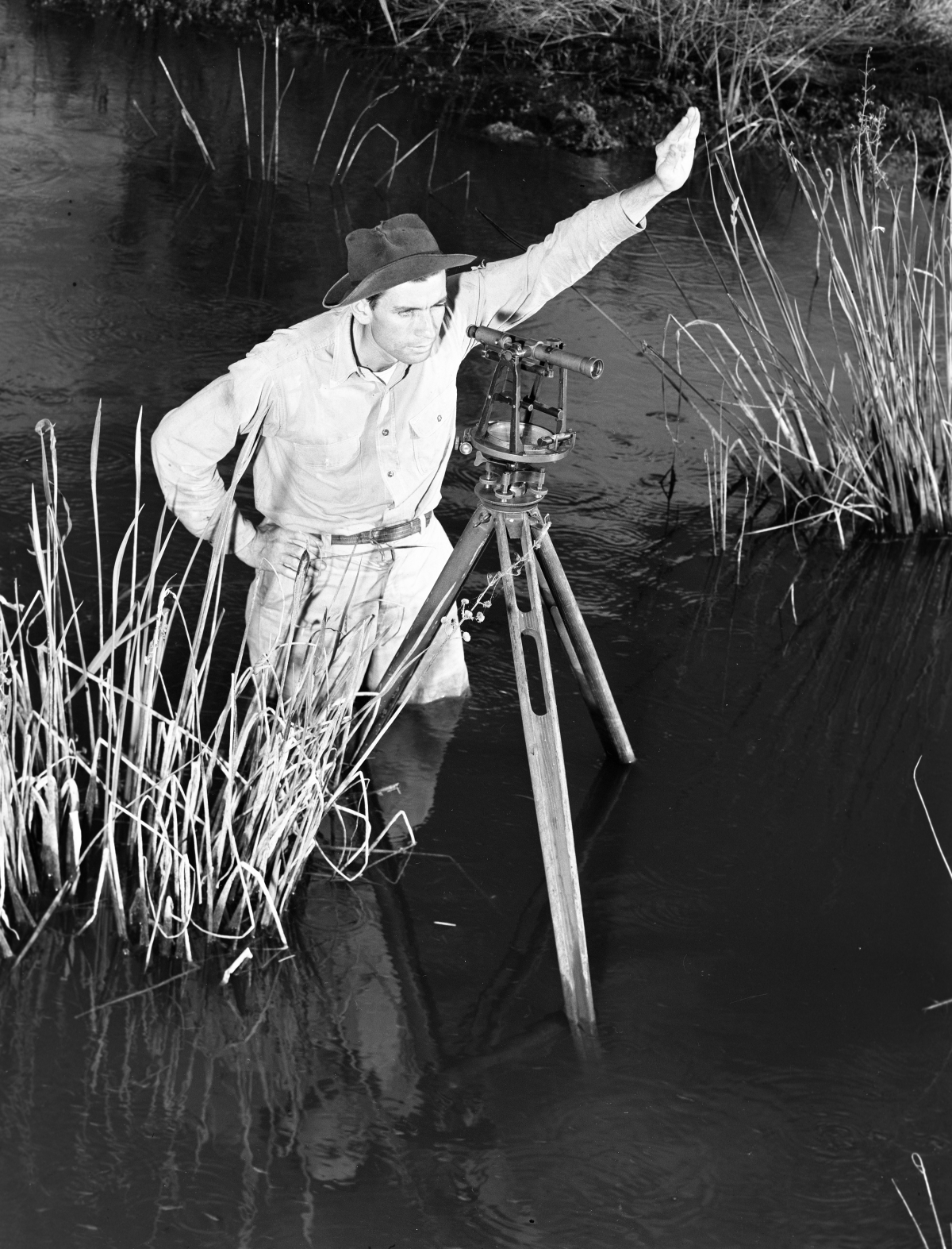 Herman Terrill standing in water surveys untouched township - Copeland, Florida