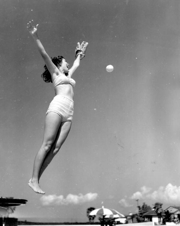 Fielder , Jeanne Crow in the air just misses the ball - Saint Petersburg, Florida .