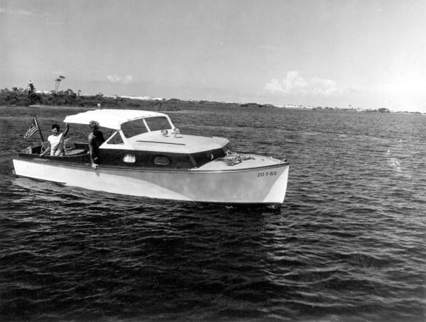 Rudy Becker, 13, and Robert McClure, 16, cruise in their boat, "Little Chick"