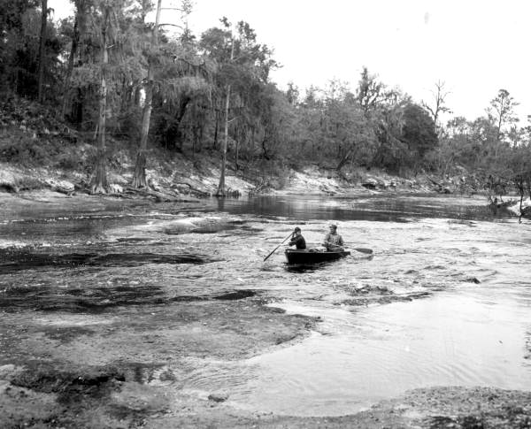 Von Walker and Bill Buford traveling through the rapids of Suwannee River .