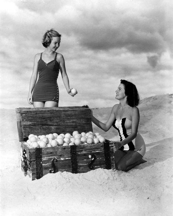 Jane Strickland (left) and Margie Fletcher in a beach scene, posing with orange-filled treasure chest - Winter Haven, Florida