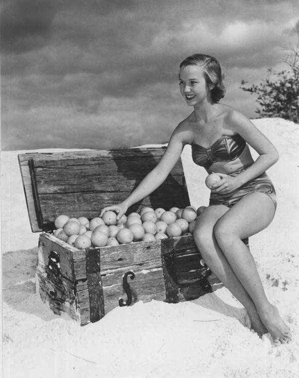 Jane Strickland in a beach scene, posing with orange-filled treasure chest - Winter Haven, Florida