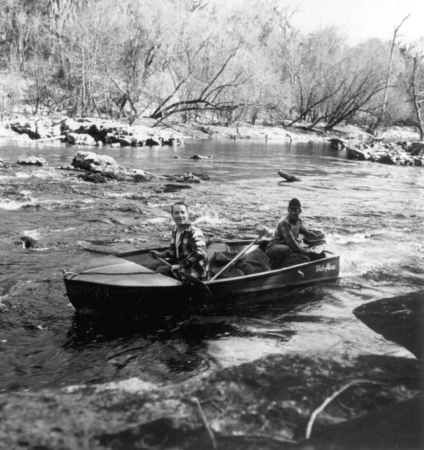 Men running the rapids in the Suwannee River.