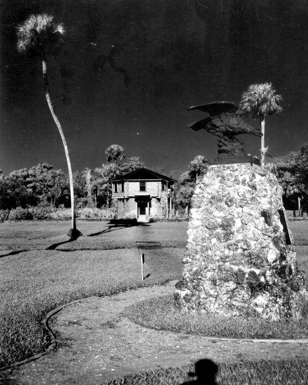 View of memorial with block house visitors' center in background at the Collier-Seminole State Park - Collier County, Florida