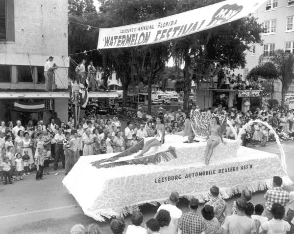 Young women on the Leesburg automobile dealers association float in the parade at the watermelon festival - Leesburg, Florida
