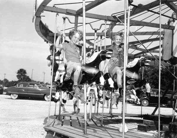 Children enjoying the merry-go-round at the watermelon festival carnival - Leesburg, Florida
