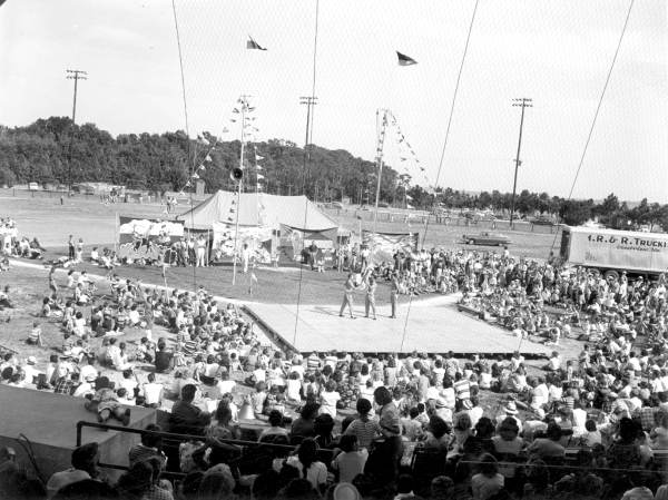 Crowd watching acrobats perform at the watermelon festival carnival - Leesburg, Florida
