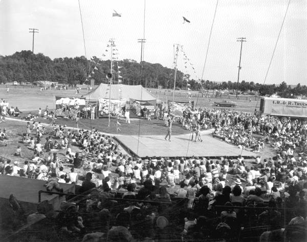 Crowd watching acrobats perform at the watermelon festival carnival - Leesburg, Florida