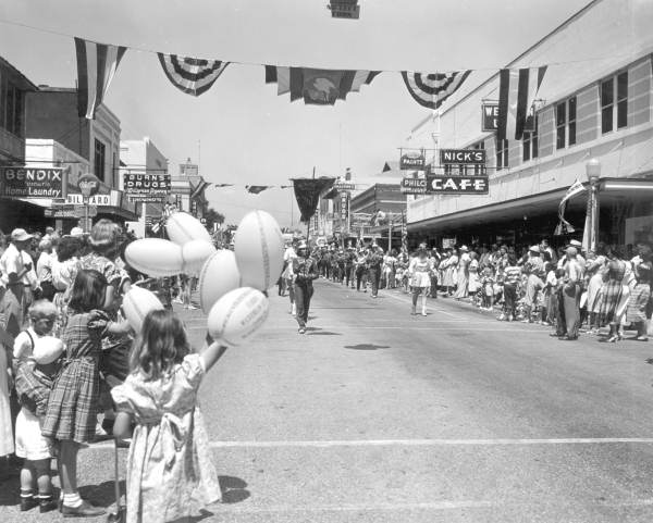 Crowd watching marching band in the parade at the watermelon festival - Leesburg, Florida