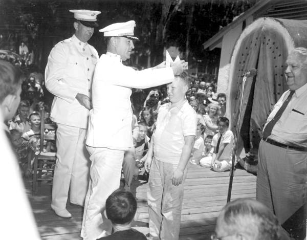 Young boy being crowned by Marine Corps officer as the winner of the watermelon eating contest in the watermelon festival - Leesburg, Florida