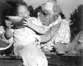 Clown encouraging young boy at the watermelon eating contest in the watermelon festival - Leesburg, Florida