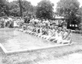 Beauty contestants seated at the edge of a pool in the watermelon festival - Leesburg, Florida