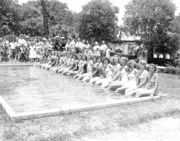 Beauty contestants seated at the edge of a pool in the watermelon festival - Leesburg, Florida