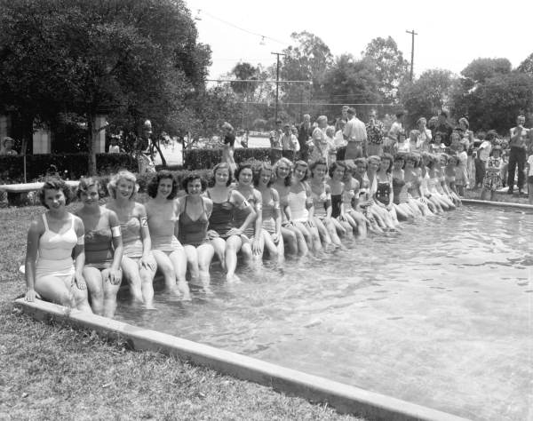 Beauty contestants seated at the edge of a pool in the watermelon festival - Leesburg, Florida