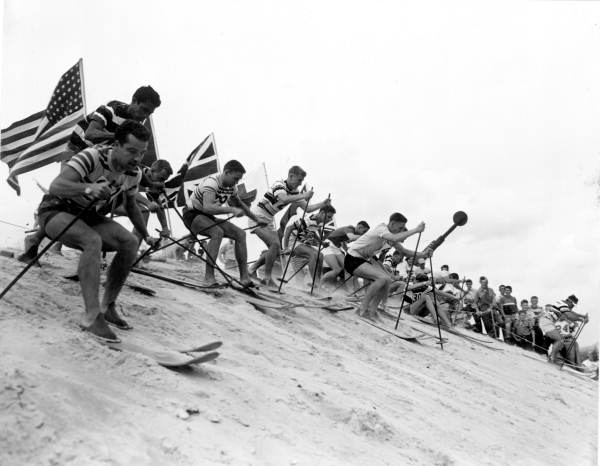 Group of skiers go down the mountain of sand - Fort Meade, Florida .