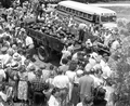 People gathered around tables and truck to get free watermelon slices at the watermelon festival - Leesburg, Florida