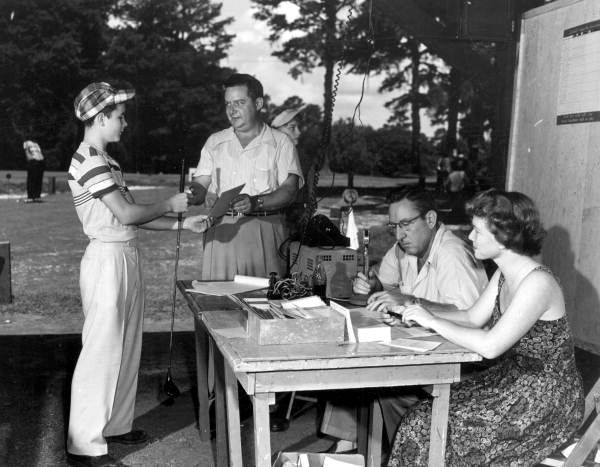 Sonny Hay presents a boy with a new golf ball and set of rules - Tallahassee, Florida