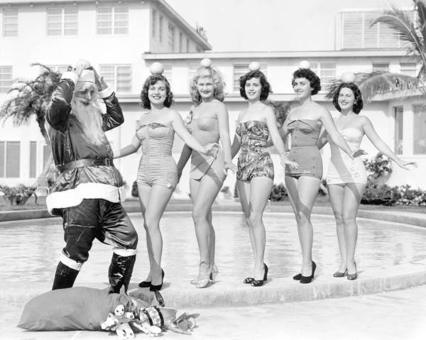 Young women celebrate Christmas with Santa Claus - Saint Petersburg, Florida
