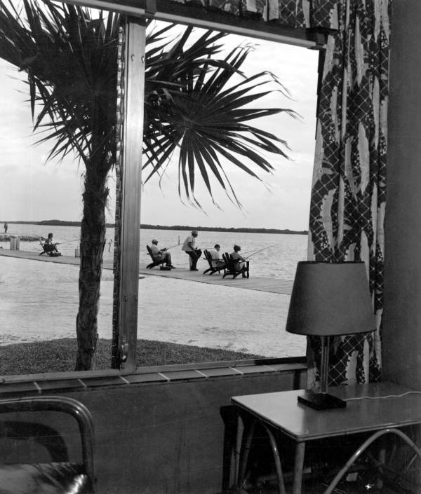 View of men fishing through a Key Motel room window - Marathon, Florida.