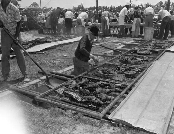 Two men broiling ribs at the Mathews Bridge barbecue - Jacksonville, Florida