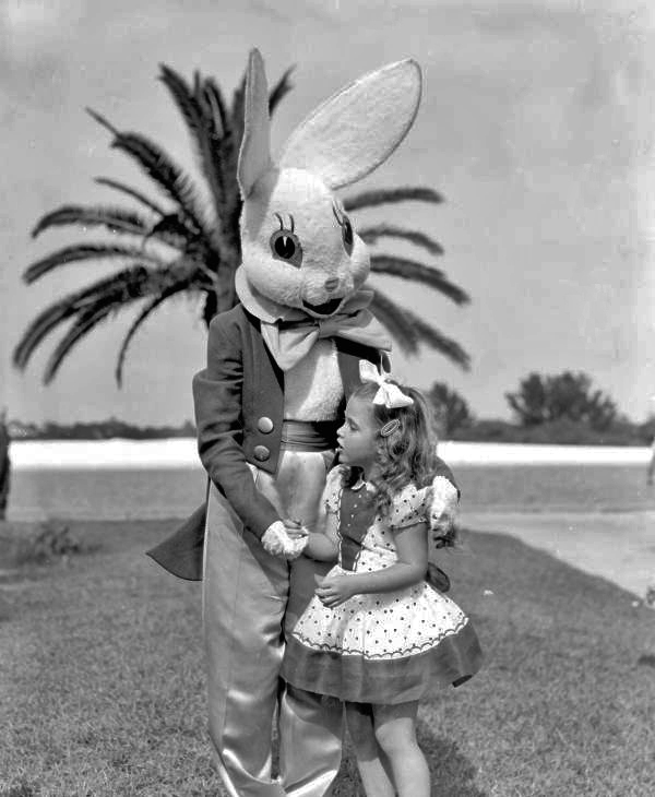A young girl poses with the "easter bunny"